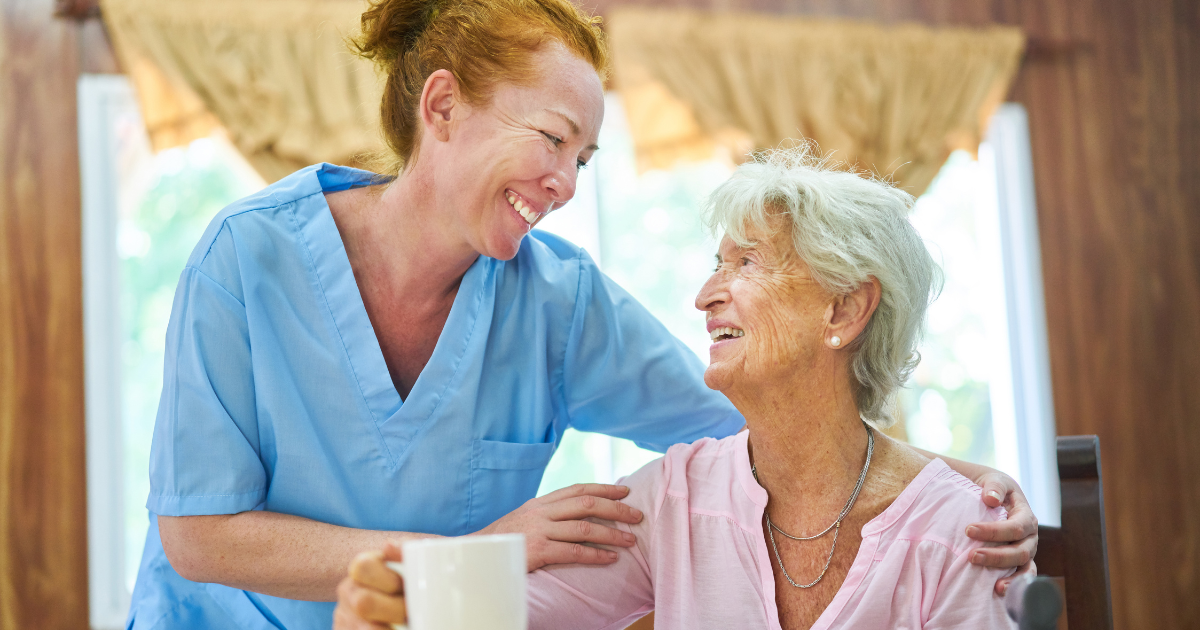 A caregiver provides home care services with a compassionate touch that helps her senior client stay happy and independent at home.