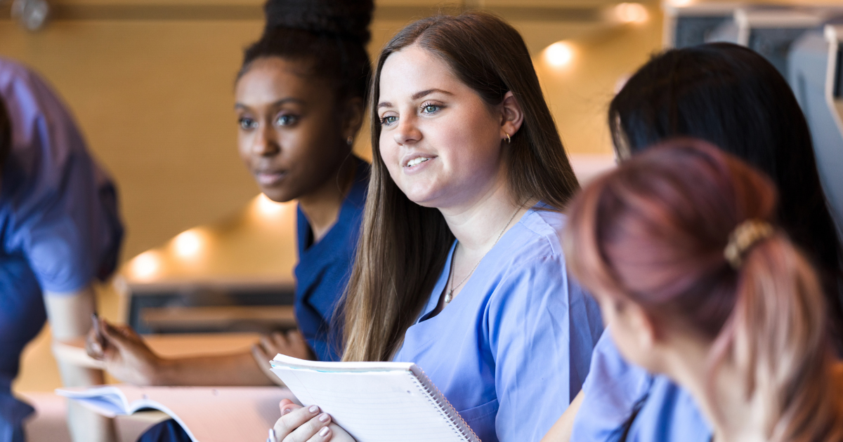 Professional caregivers pay attention and take notes as they attend a class.