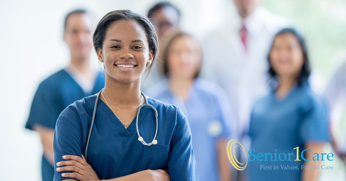 A smiling nurse stand with other nurses and professionals in the background.