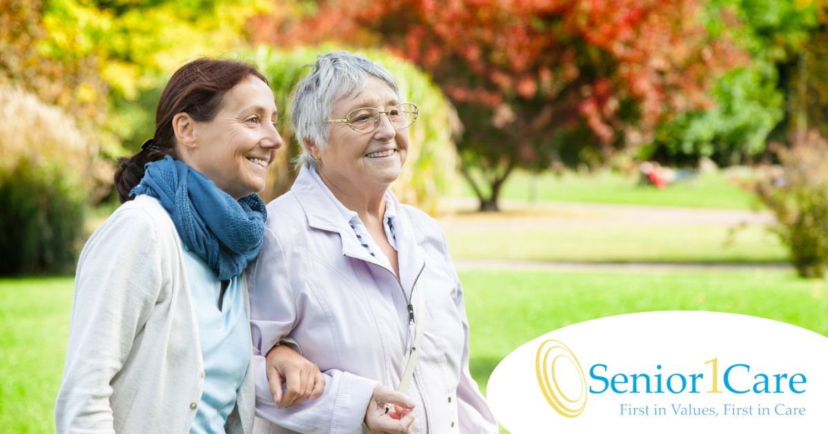 A recently retired woman enjoys her caregiving job as she walks with a senior client outside.