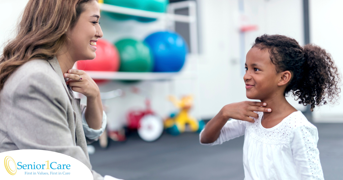 A speech pathologist works with a young girl to improve her communication through speech therapy.