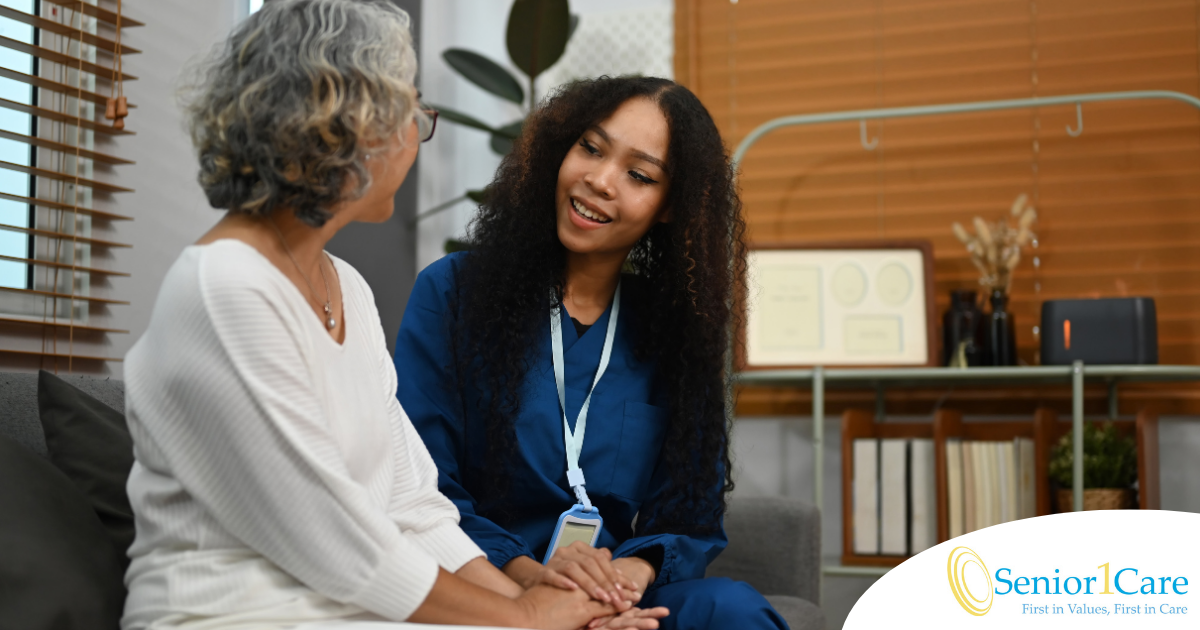 A caregiver patiently and kindly sits down and talks with a senior client, setting a good example for caregivers when it comes to communication.