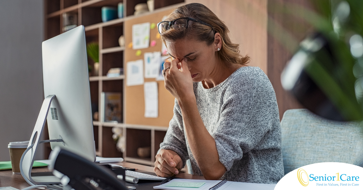 A woman is exhausted at her job as a result of struggling with balancing caregiving and her career.