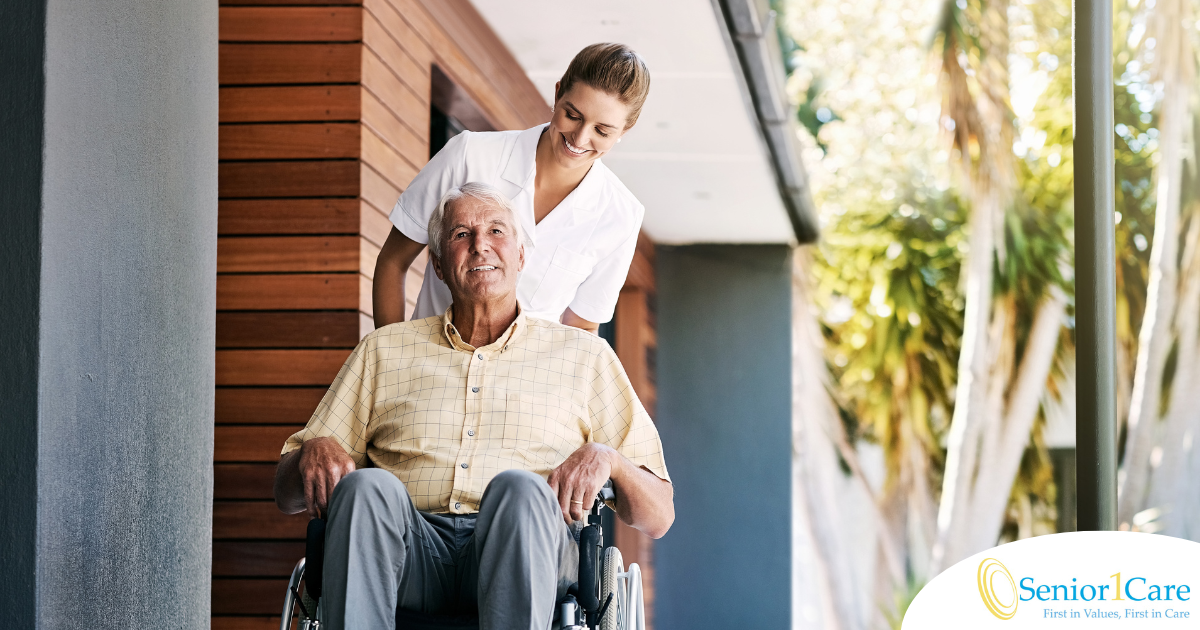 A caregiver brings an elderly man in a wheelchair out of a building, demonstrating a hospital discharge.