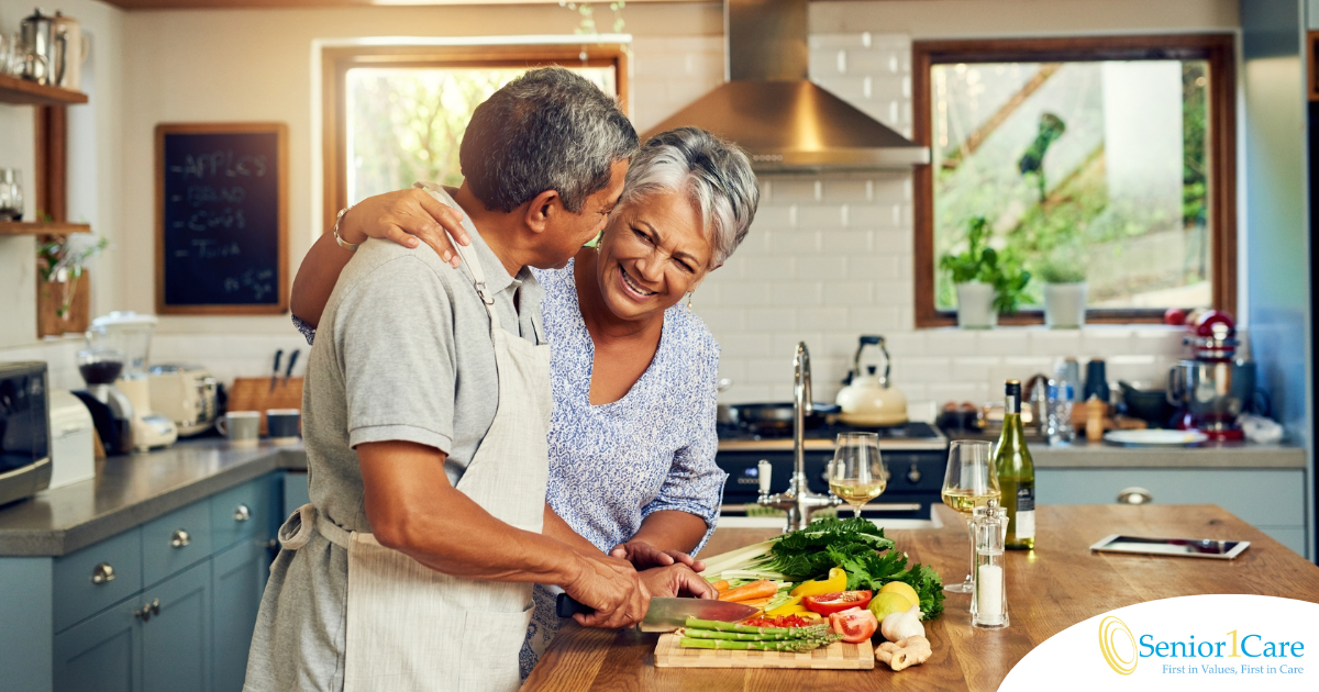 A senior couple enjoys cooking a healthy meal together, representing National Nutrition Month.