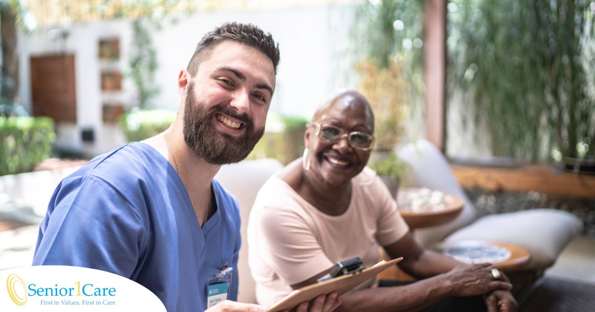 A man enjoys his caregiver job as he works with a client.