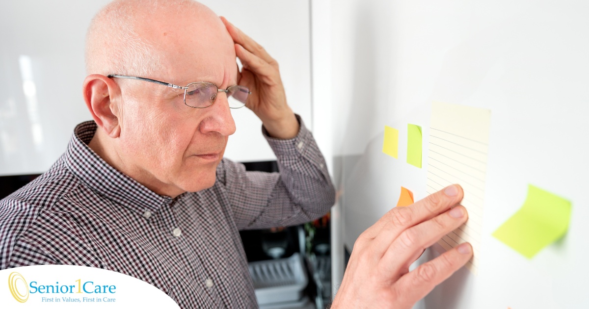 A senior looks at a board confused, representing one of the potential signs of dementia.