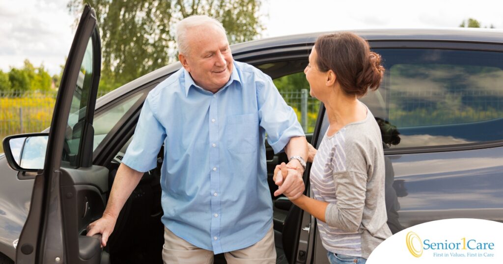 A caregiver helps a senior carefully get out of the care, representing the safety that those who work in home care should strive for.