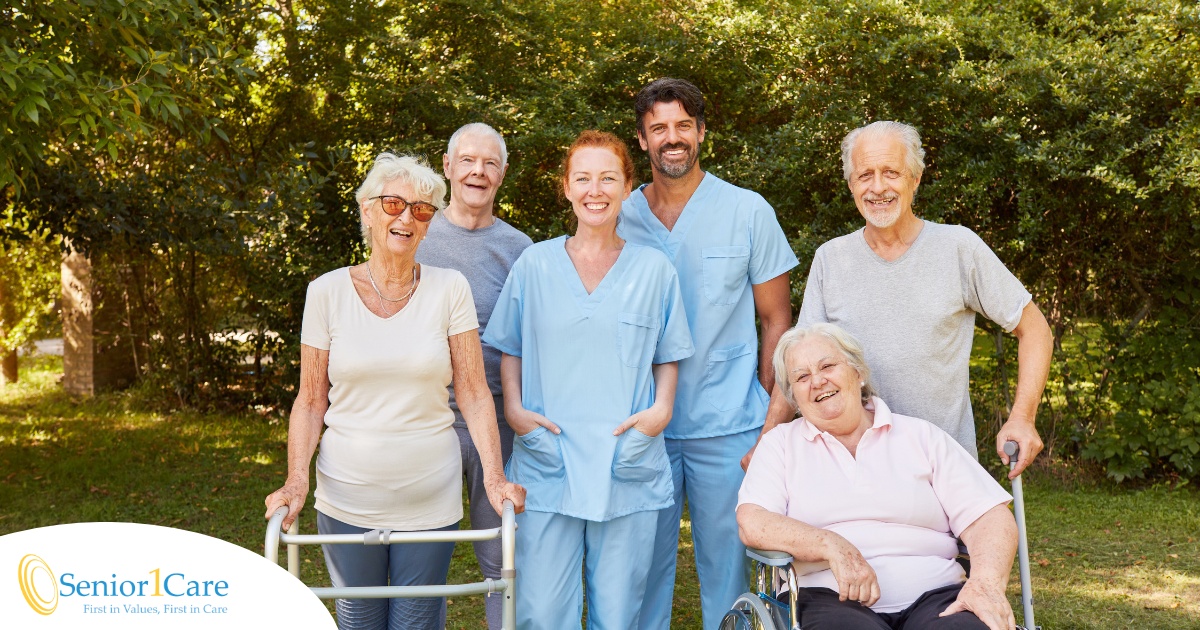 2 caregivers and seniors smile while in a group representing how caregivers can facilitate socialization.