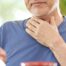 An older adult holds his throat representing dysphagia which can affect senior health.