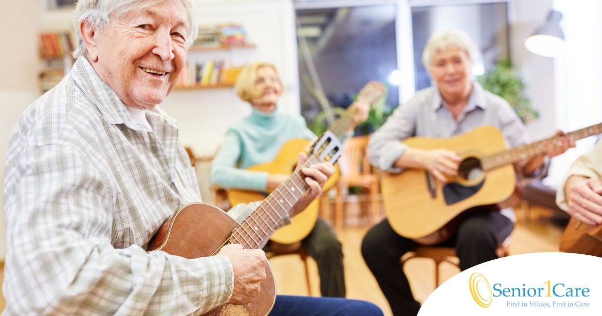 A compassionate young caregiver with a stethoscope around her neck gently looks after an elderly woman sitting on a couch, showing the warmth and connection possible through in-home care.