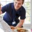 Professional caregiving involves helping clients with iADLs and ADLs as demonstrated by this caregiver helping a client by bringing a meal.