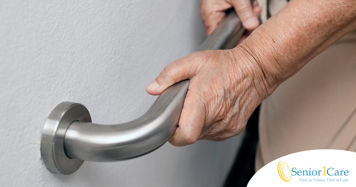 An older adult uses a grab bar representing one of the home modifications that is helpful for fall prevention for elderly adults.