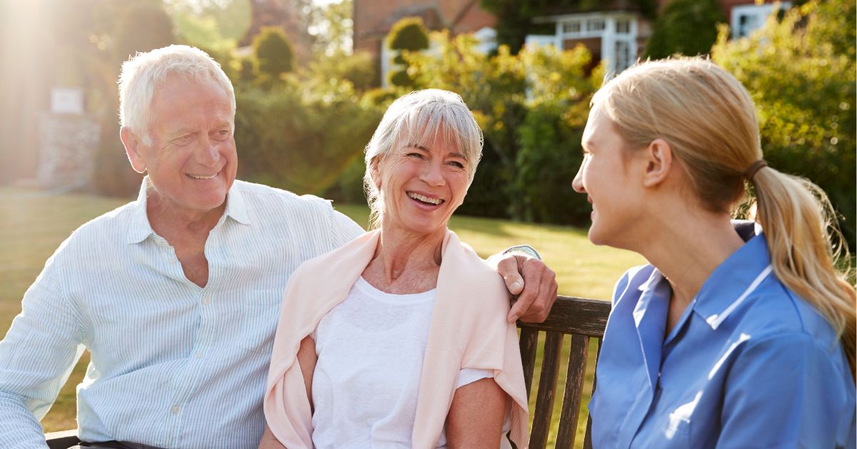 In-home caregiver spending quality time with senior couple outdoors in Huntertown