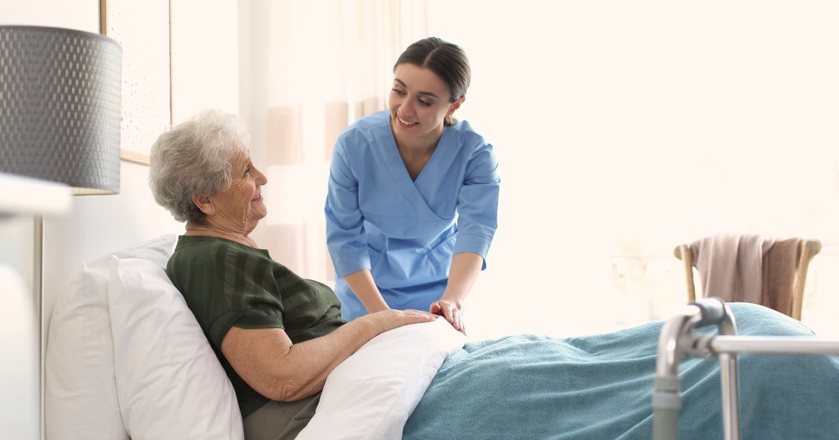 Caregiver providing bedside recovery care and emotional support to a senior in Granger