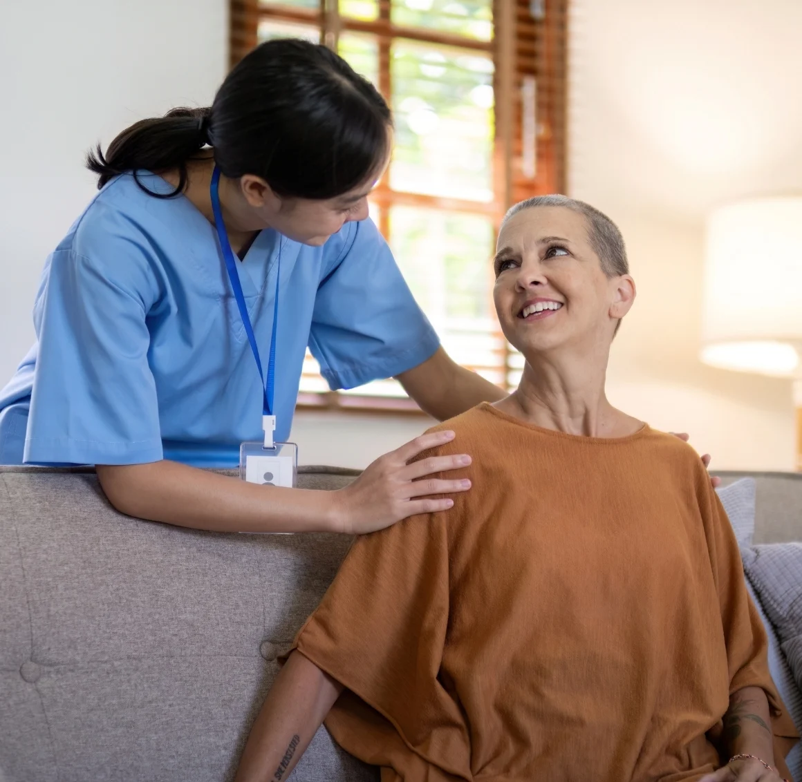 Companionship Care in Greenwood (1) A caregiver offers reassurance to her client with a gentle hand on the shoulder, reflecting Companionship Care in Greenwood, IN.